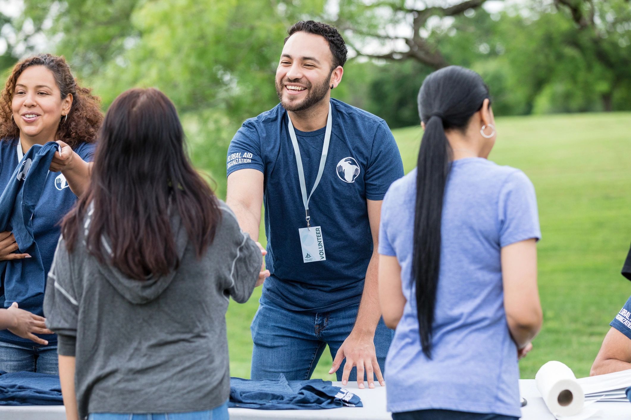 Volunteers greeting community members at an outreach event