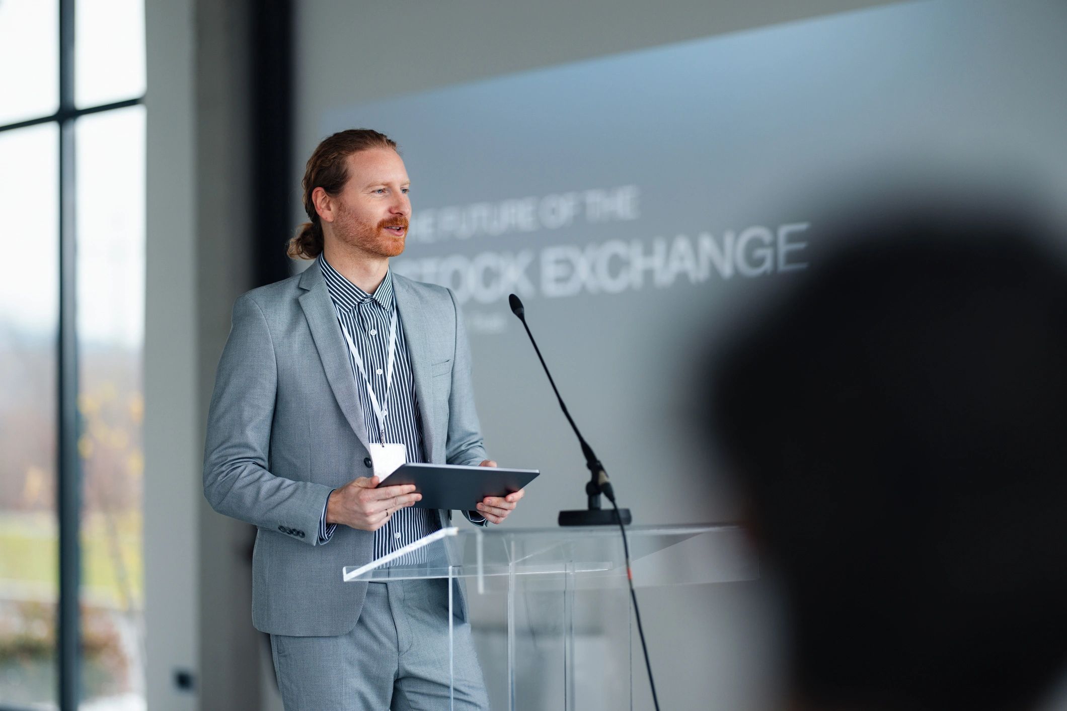 Speaker presenting at a podium with microphone