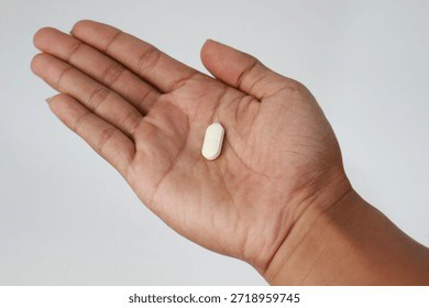 Close-up of a hand holding a pill for abortion reversal pill event topic